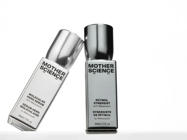 Two bottles of Mother Science skincare products, one labeled "Molecular Hero Serum" and the other "Retinol Synergist," set against a plain white background.